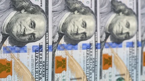 US 100 dollar bills close up tracking. Slider shot, low angle. 4K Stock Footage 125566486
