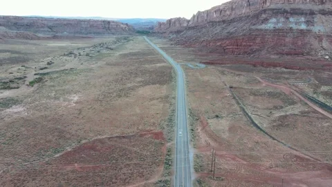 US 191 Moab Utah Arches National Park Outskirts Pan up to Road Reveal Rock 스톡 동영상 154173462