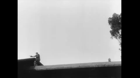 US - 1914 - in this silent comedy, a boxer chases his opponent over a rooftop. Stock Footage 337953722