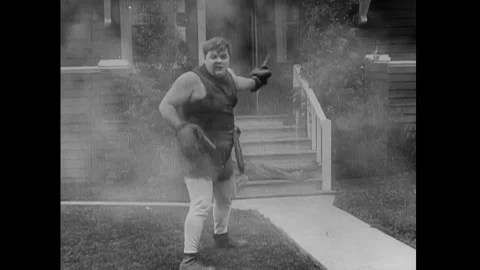 US - 1914 - in this silent comedy, a boxer, who is chasing his opponent, crashes Stock Footage 337953734