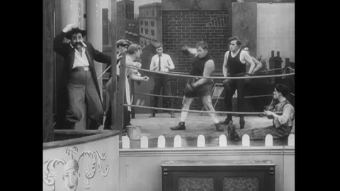 US - 1914 - in this silent comedy, when a boxer is losing, he grabs a man's guns Stock Footage 337953649