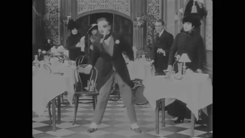 US - 1915, in this silent comedy, a man is cleaning his teeth with a plant stalk Stock Footage 284719569