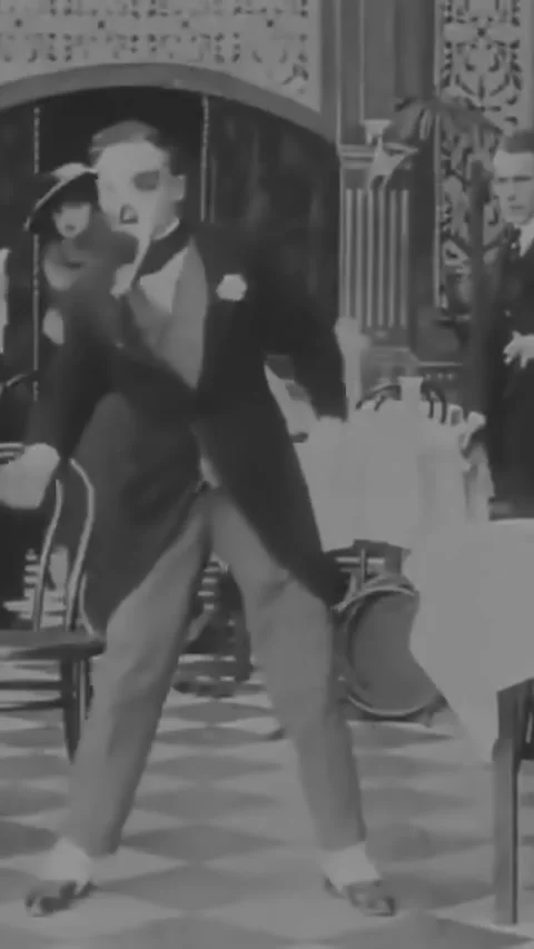 US - 1915, in this silent comedy, a man is cleaning his teeth with a plant stalk Stock Footage 339131924