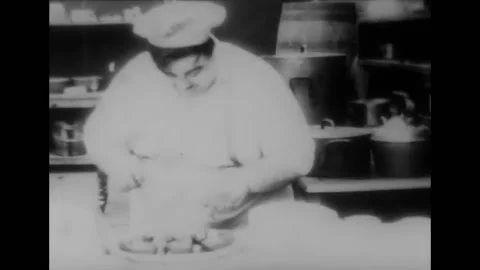 US - 1916 - in this silent comedy, a cook makes a string of sausages slither 動画素材 261570361