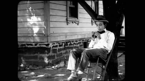 US - 1916 - in this silent comedy, a man pretends to be unwell to avoid working. Stock Footage 296169274