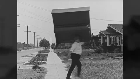 US - 1920 - in this silent comedy, a deliveryman carries a piano all by himself Stock Footage 325202474