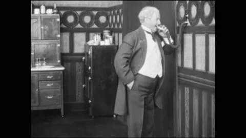 US - 1920 - in this silent comedy, a man puts powder through a home intercom, Stock Footage 272364242