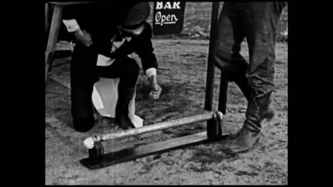 US - 1920 - in this silent comedy, a man drinks at an illegal bootlegging set up Stock Footage 277299489