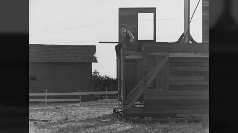 US - 1920 - in this silent comedy, a man sits on the wrong end of a wooden beam Stock Footage 325215664