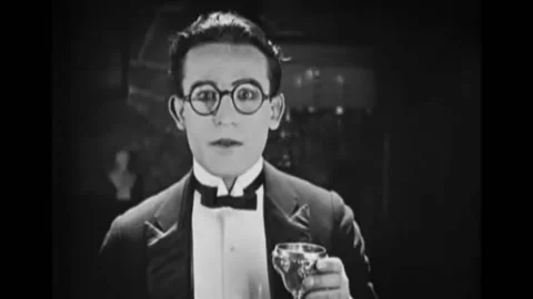 US - 1921 - in this silent comedy, a man drinks a strong punch at a party and Stock Footage 277298212