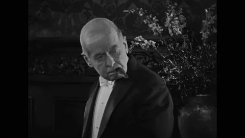US - 1925 - in this silent comedy, a criminal posing as a detective inspects a Stock Footage 327680560