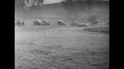 US - 1925 - in this silent comedy, during a pit stop at a car race, a cop tries Stock Footage 325208569