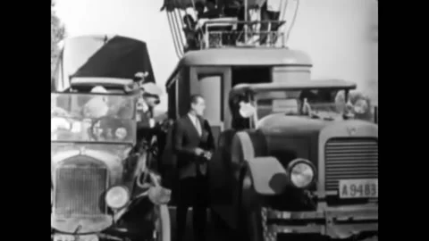 US - 1925 - in this silent comedy, a man whose car is stuck in mud refuses help Stock Footage 325217270