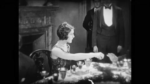US - 1925 - in this silent comedy, people are having a dinner party. A woman Stock Footage 296170420