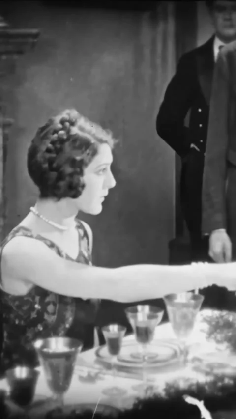 US - 1925 - in this silent comedy, people are having a dinner party. A woman Stock Footage 340194944