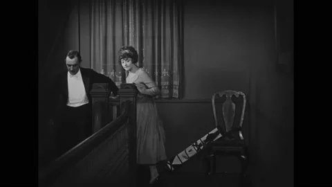 US - 1925 - in this silent comedy, two thieves carefully make their way down the Stock Footage 327680893