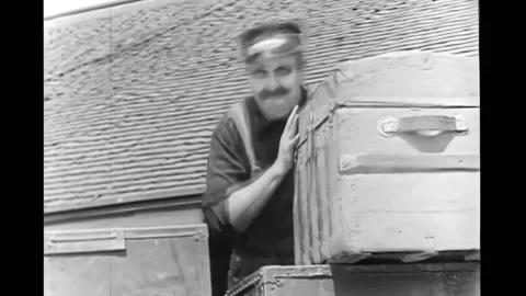 US - 1925 - in this silent comedy, a worker throws a wooden chest from a mail Stock Footage 296406776