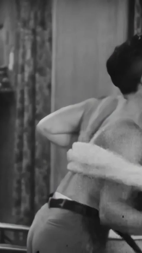 US - 1928 - in this comedy, a man hurries to get dressed, and he grabs his tie Stock Footage 339512605