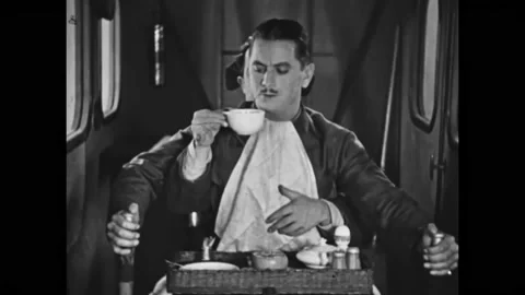 US - 1928 - in this silent comedy, the copilot brings a cup of coffee to the Stock Footage 296167765