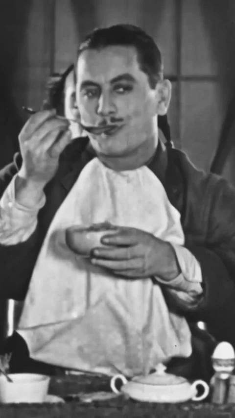 US - 1928 - in this silent comedy, the copilot tries to feed the pilot while he Stock Footage 339780770