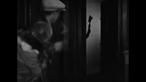 US - 1928 - in this silent comedy, a couple hides from the maid, believing she's Stock Footage 341984042