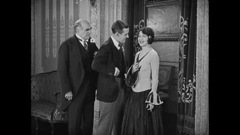 US - 1928 - in this silent comedy, a guest at a party shows a couple a trick, in Stock Footage 341341002