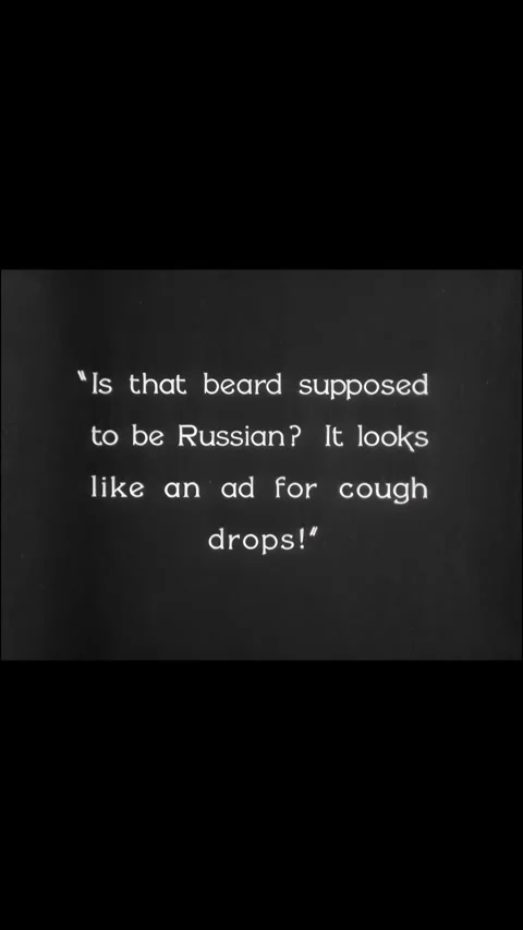 US - 1928 - in this silent comedy, a man rips off the fake beard of a customer Stock Footage 339510896