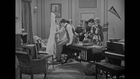 US - 1928 - in this silent comedy, several women hoist a man down through the Vídeos de archivo 277282717