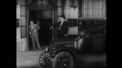 US - 1928 - in this silent comedy, two men get into their car, laughing nonstop Stock Footage 288079188