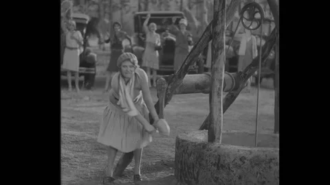US - 1929 - in this comedy, a woman pulls her father out of a well while a Stock Footage 313139777