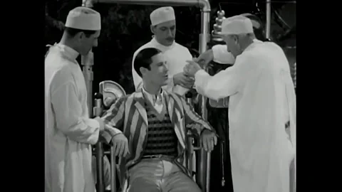 US - 1930 - in this comedy, a doctor examines a patient's tonsils and asks him Stock Footage 340582458
