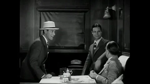 US - 1930 - in this comedy, a famous man traveling by train begs two reporters Stock Footage 340582433