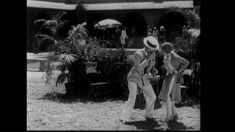 US - 1930 - in this comedy, a man crawls on the grass, trying to approach his Stock Footage 296167559