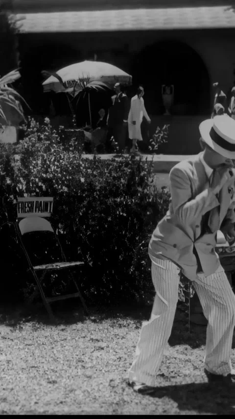 US - 1930 - in this comedy, a man crawls on the grass, trying to approach his Stock Footage 339780112