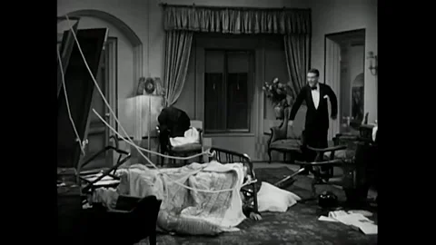 US - 1930 - in this comedy, a man enters his friend's hotel room and finds him Video stock 340582452
