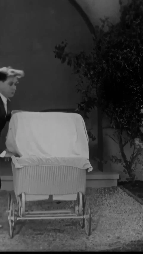 US - 1930 - in this comedy, a man hides in a stroller from his gun-wielding wife Stock Footage 339780083