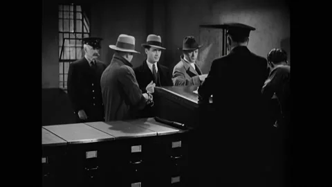 US - 1930 - in this drama, a captain processes a man for prison, asking him Stock Footage 330603507