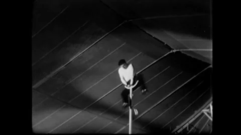 US - 1933 - An acrobat performs for a crowd at a circus. Stock Footage 340585825