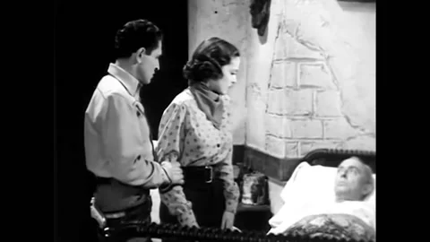 US - 1937 - in this western, a wounded, bedridden man reproaches his rival's Stock Footage 325213260