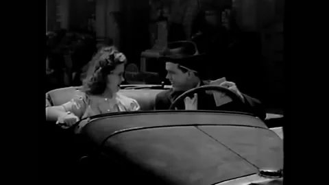 US - 1940 - in this comedy, a boy asks his girlfriend in his car if he can bring Stock Footage 264667445