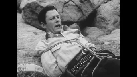 US - 1941 - in this western, a bound prisoner convinces a girl to untie him, Stock Footage 341342660