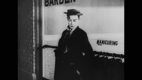 US - 1944 - in this silent comedy, a young man stands outside a beauty salon, Stock Footage 254192243