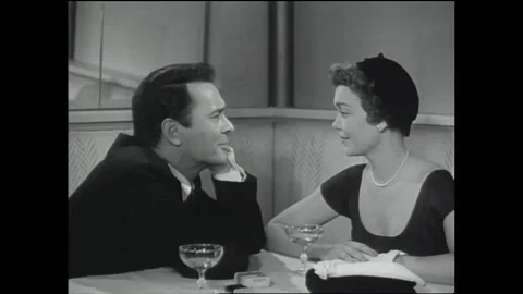 US - 1951 - in this romance, during dinner at a restaurant, a man compliments Stock Footage 341323528