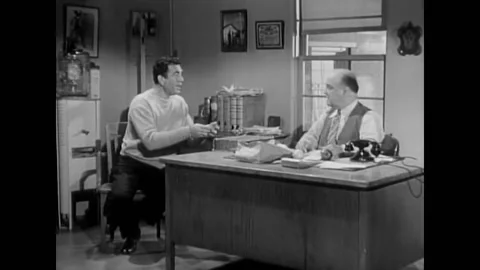 US - 1952 - in this sitcom, a stockbroker has lunch at his desk with a failed Stock Footage 328185977