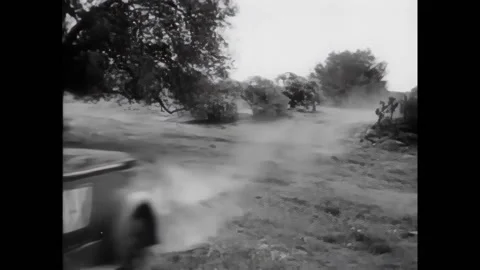 US - 1955 - in this comedy, a car comes racing into town to stop a bank robber. Stock Footage 296396929