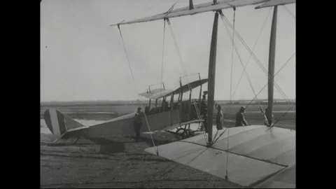 U.S. air Cadet taking off plane after checking all parts of airplane, 1917 - Stock Footage 83660239
