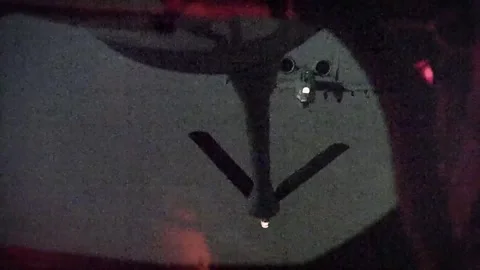 U.S. Air Force A10 Thunderbolt II approaching boom at night for aerial refueling Video stock 289190298