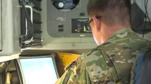 U.S. Air Force airman working on laptop computer onboard C-17 Globemaster  Stock Footage 260883267
