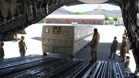 U.S Air Force airmen load casket containing MQ-9 Reaper onto C-17 Globemaster Video stock 295275915