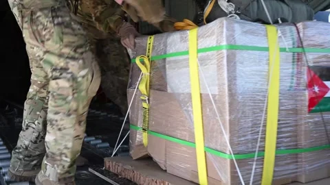 U.S. Air Force airmen loading pallet of humanitarian aid for Gaza onto aircraft Stock Footage 267679593